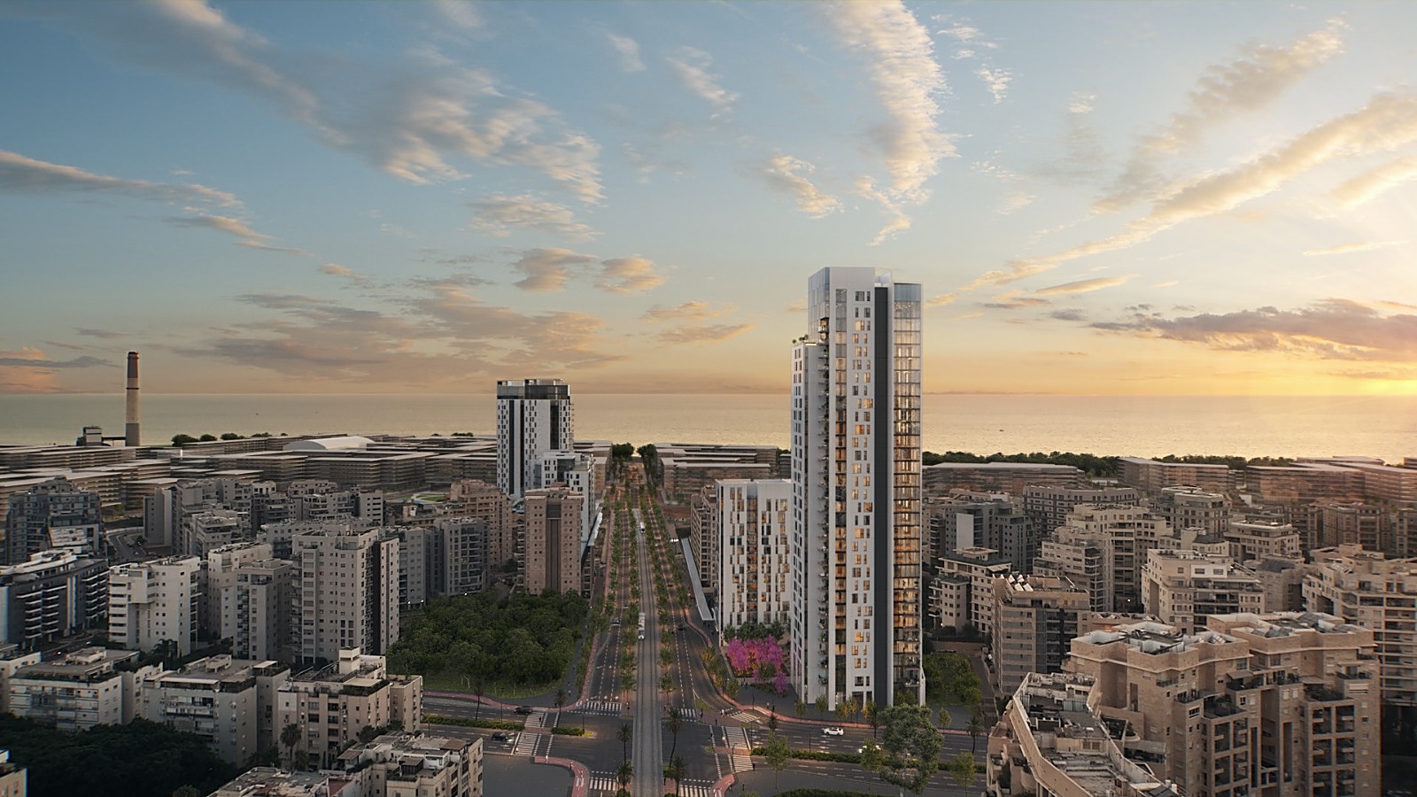 A residential tower and the Tel Aviv skyline at dusk, looking toward the sea