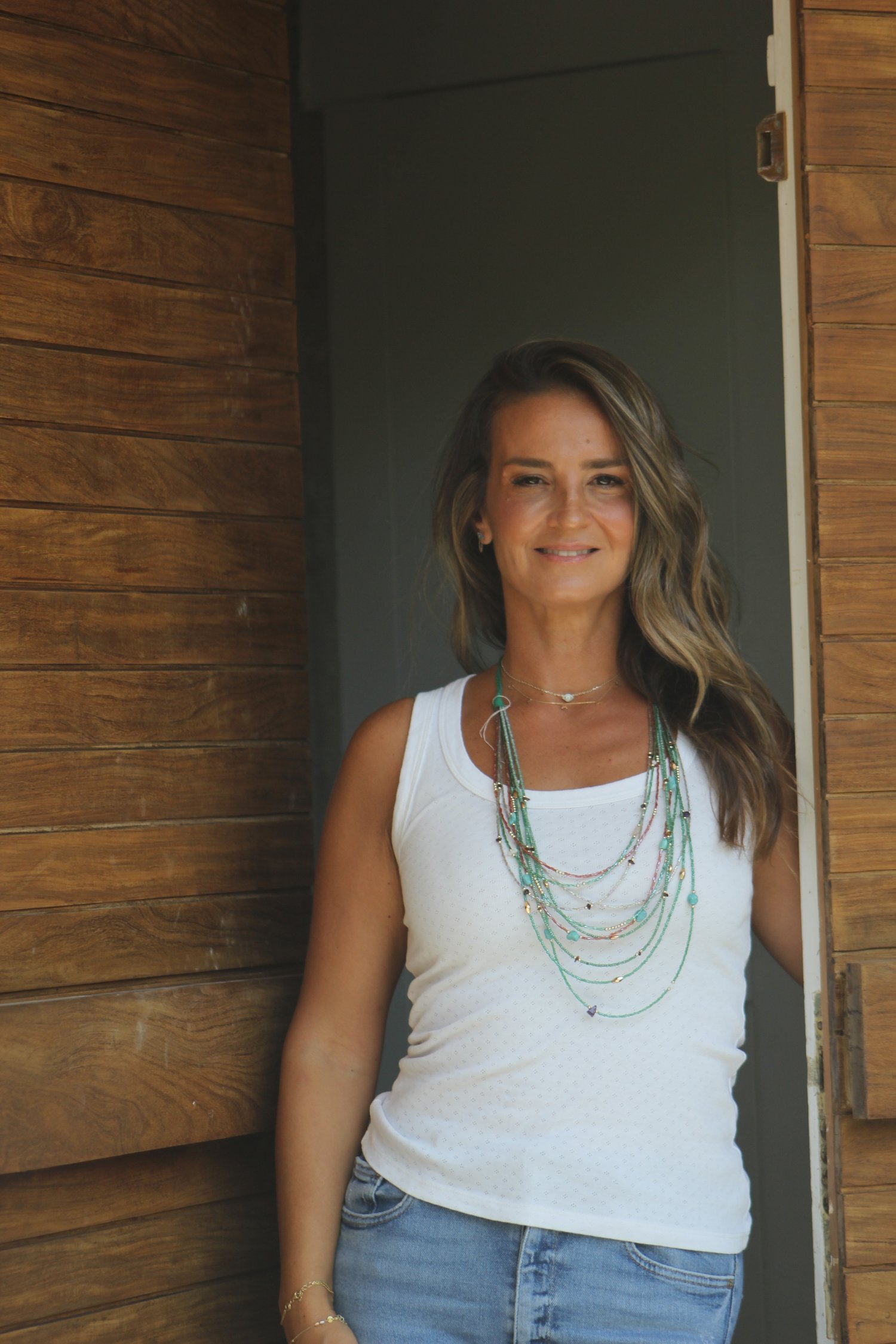Sandra R. Dayan standing in a sunlit doorway